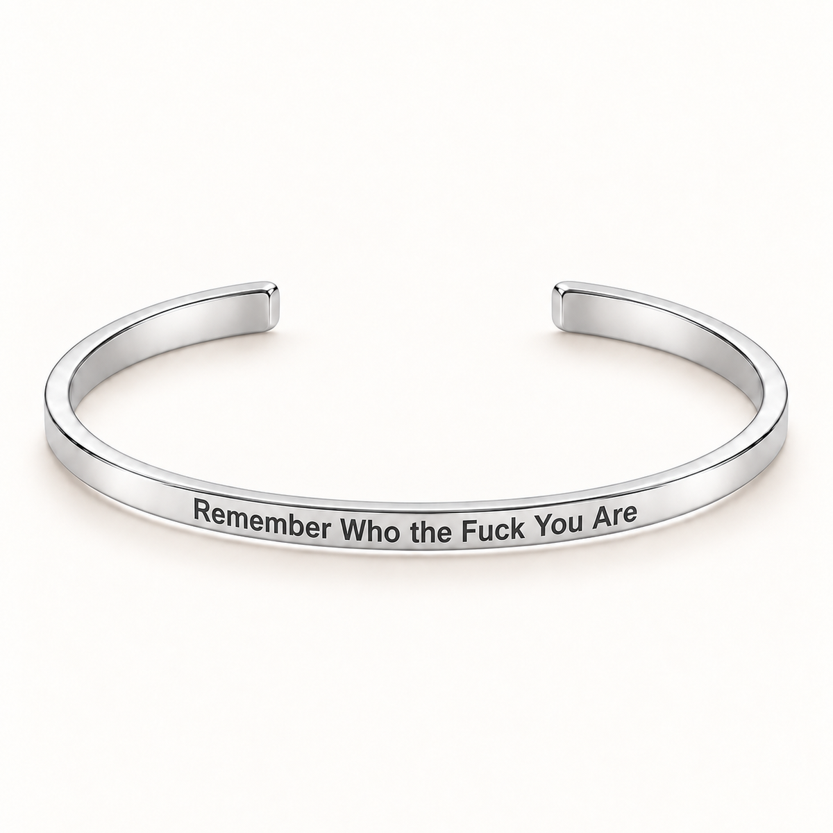 Silver open Slim Cuff with Remember Who the Fuck You Are engraved on the outside