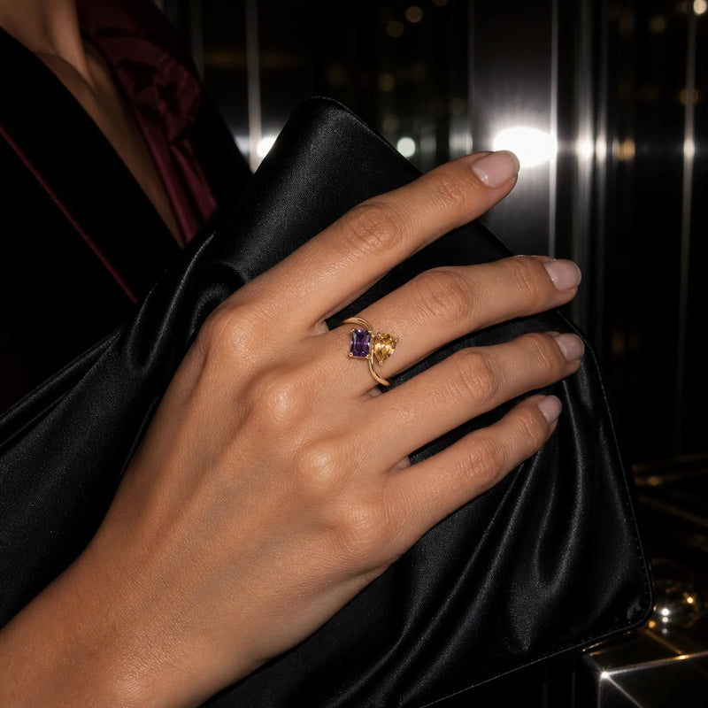 Gold Toi et Moi ring with amethyst and citrine stones worn on an evening out